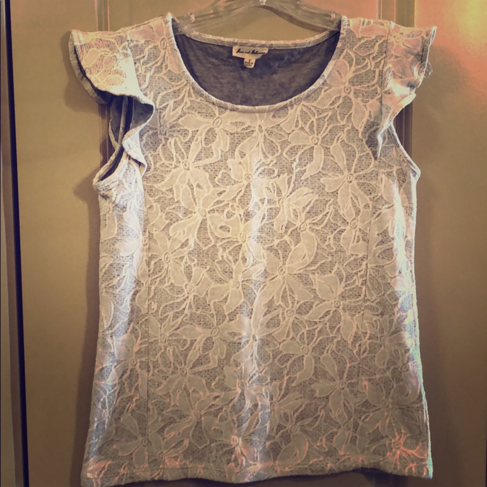 Women’s gray and white flower shirt with ruffles.